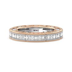 Like your love that has no end, this diamond eternity ring shines ceaselessly. This band features a timeless allure inspired by the Victorian era. It features a sculpted, multi-layered, and textured band in yellow gold. The edges are traced with milgrain detailing while the hollow sections are filled with a carved scroll pattern in white gold. Alternating round and baguette-cut diamonds run along the band's entire circumference. Luxury Baguette-cut Eternity Band With Vvs Clarity, Luxury Rose Gold Eternity Band With Diamond Accents, Luxury 14k Rose Gold Eternity Band, Luxury Multi-stone Yellow Gold Eternity Band, Luxury Baguette-cut Eternity Band With Diamond Accents, Scroll Pattern, Gorgeous Engagement Ring, Baguette Cut Diamond, Eternity Ring Diamond