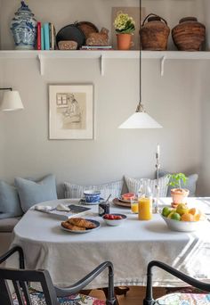 the breakfast table is set with fruit and juice