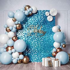 a blue and gold birthday backdrop with balloons