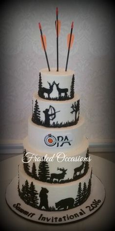 a three tiered cake decorated with deer and arrows