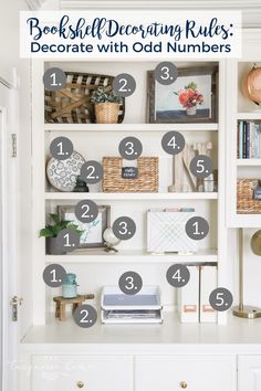 a white bookcase filled with lots of books and other things on top of it