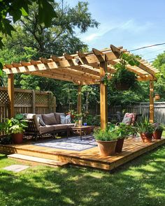 a wooden deck with potted plants on it and an attached pergoline over the top