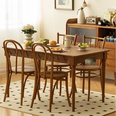 a dining room table with four chairs around it