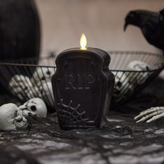 a candle that is sitting in front of some skulls