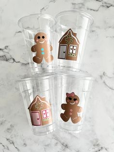 four plastic cups with gingerbread designs on them