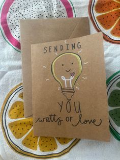 a greeting card with an image of a light bulb and the words sending you hearts of love