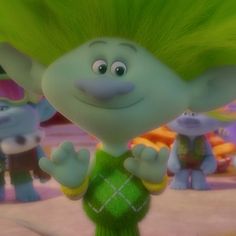 an animated character with green hair standing in front of other characters