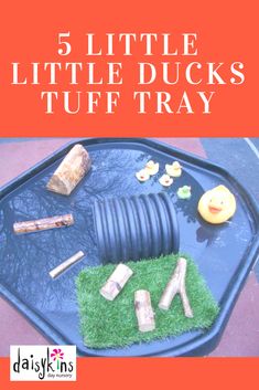 there is a blue tray with toys on it and the words 5 little duck's tuff tray