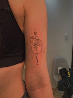 a woman's arm with a snake tattoo on the left side of her body