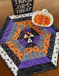 a trick or treat table topper with candy in a bowl