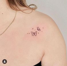 the back of a woman's shoulder with a small butterfly tattoo on her left shoulder