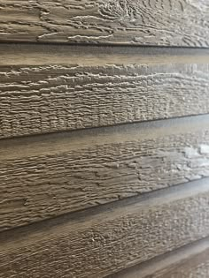 close up view of the wood grains on a house's exterior siding wall