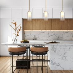 a kitchen with marble counter tops and stools