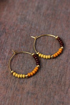 Unique boho earrings with glass seed beads (dark chocolate brown,mustard-yellow colors), small gold tone metal beads and gold tone stainless steel round hoop earrings. Earring hooks are from nickel free and lead free metal. Perfect jewelry for everyday wear or a great gift for someone special! Diameter of hoops is 25 mm Other earrings of my shop you can see here: https://www.etsy.com/shop/NaTavelli?section_id=13757927  Thanks for visit. Brown Beaded Hoop Earrings As Gift, Brown Beaded Hoop Earrings For Gift, Handmade Brown Small Hoop Earrings, Handmade Small Brown Hoop Earrings, Brown Beaded Bohemian Hoop Earrings, Brown Bohemian Beaded Hoop Earrings, Bohemian Brown Beaded Hoop Earrings, Brown Beaded Hoop Earrings, Earrings Seed Beads