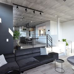 a living room filled with furniture and lots of windows