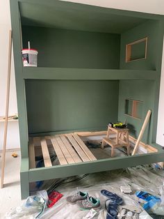 a bunk bed built into the side of a wall in a room that is being remodeled