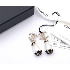 Chanel Brand New Gold Scallop CC Black Flower Pearl Large Piercing Earrings  *Marked 21 *Made in France *Comes with original pouch, box, ribbon, booklet and tag *Brand new  -Approximately 0.6″ x 1.75″ -Very unique  We confirm orders within 1 business day and ship within 1- 2 business days. 18083-7221  Please see the measurements section for best approximate dimensions. Luxury White Earrings For Evening, Luxury White Evening Earrings, Designer Black Earrings For Gift, Designer Drop Earrings For Evening, Designer White Earrings For Evening, Designer White Earrings For Party, Prada Jewelry, Box Ribbon, Chanel Brand