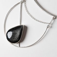 This one of a kind statement piece is hand fabricated in sterling silver, with a beautiful silver sheen obsidian. Collar size is slightly adjustable. Handcrafted in San Francisco. In stock and ready to ship. Adjustable Teardrop Jewelry With Polished Finish, Modern Adjustable Jewelry With Large Stone, Black Artisan Jewelry With Polished Finish, Modern Silver Gemstone Necklaces, Artisan Black Jewelry With Polished Finish, Silver Minimalist Jewelry With Large Stone, Minimalist Silver Jewelry With Large Stone, Black Sterling Silver Jewelry, Silver Onyx Necklace With Polished Finish