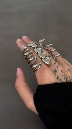 Perfectly balancing both soft and aggressive design. This statement ring demands attention be brought forth to its impressive double-banded architecture, connected by the dichotomy of spikes and a heart. Luxuriously weighted and effortlessly smooth to put on. To purchase the correct size, measure the biggest finger you’ll style it on. Edgy Silver Metal Rings, Unique Claw-shaped Metal Rings, Unique Claw Shaped Metal Rings, Punk Style Metal Open Ring, Edgy Silver Open Ring Jewelry, Gothic Metal Jewelry With Spikes, Silver Punk Claw Rings, Punk Style Metal Open Ring Jewelry, Edgy Silver Jewelry With Spikes