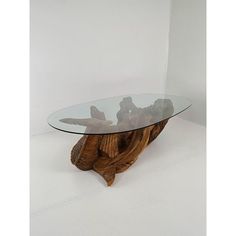 a glass table with wooden carvings on it