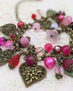 "- Vintage Style Valentines Charm Bracelet Bronze Chain is adjustable from 6.5\" - 8\" with an extension chain The bracelet links are filled with crystals, glass beads and pearls in shades of pink and red Mixed between the beads are vintage style heart charms - all are bronze, some have patina Search my store categories \"Necklaces\" and \"Earrings\" for matching pieces. This is a great gift for Mother's Day Your bracelet will be carefully gift packaged and shipped via USPS First Class Mail. Fee Vintage Adjustable Heart Bracelet For Valentine's Day, Pink Beaded Charms Bracelets For Valentine's Day, Pink Beaded Bracelets With Charms For Valentine's Day, Bohemian Bracelets With Heart Charm For Valentine's Day, Pink Metal Beaded Bracelets With Charms, Valentine's Day Pink Beaded Bracelets With Charms, Pink Metal Beaded Bracelet With Charms, Pink Heart-shaped Jewelry With Dangling Charms, Valentine's Day Beaded Charm Bracelet