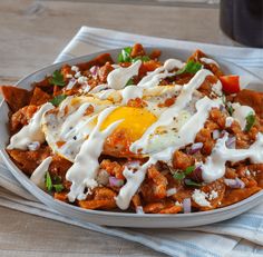 a white bowl filled with food on top of a table