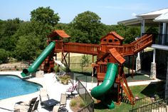 a large backyard with a pool and slide