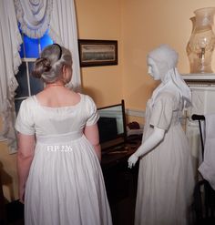 "This lovely underdress is made from two different fabrics which were sewn together to create what we know as a bodiced petticoat. The plain fabric bodice is constructed like a bib-front gown with a wide waistband. The sleeves are particularly snug and short, so they would not interfere with the sleeves of the dress or spencer worn over them. The skirt is made from a heavy dimity with 4 hem tucks and is easily worn as an outer garment. Its linen waist band was sewn to the interior of the cotton Historically Designed Fitted Dress, Daywear Dresses With Historical Design And Fitted Bodice, Fitted Cotton Dresses With Underbust Design, Regency Style Dresses With Historical Design, Fitted Regency Style Petticoat, Regency Bodiced Petticoat Pattern, Cotton Prairie Dress With Empire Waist In Regency Style, Historical Cotton Wedding Dress, Cotton Regency Prairie Dress With Empire Waist