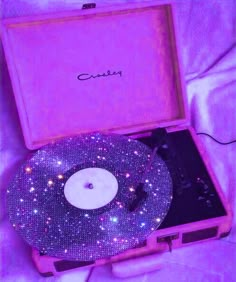 an old record player in a pink case