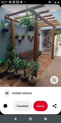 an image of a patio with potted plants on the wall and a bench in the middle