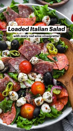 a salad with tomatoes, olives, mozzarella and prosciutto