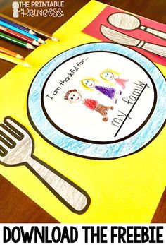 a paper plate with a fork and spoon on it next to colored crayon pencils