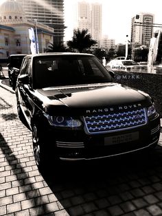 a black range rover parked on the side of a road