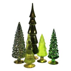 several different colored glass christmas trees on gold bases