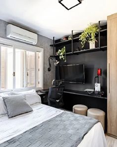 a bed room with a neatly made bed and a flat screen tv on the wall