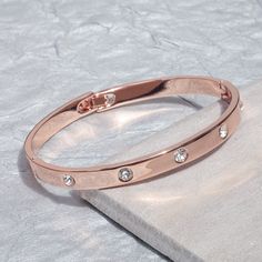 Stylish Cubic Zirconia set Cuff Bangle in Rose Gold. The perfect gift for any Birthday, Anniversary, or Christmas to your loved one. If you have any questions or would like to know additional details please feel free to reach out and ask us. We be happy to answer any question you may have. We want YOU to feel comfortable buying not only from us but also comfortable with the item you want to purchase. The Bangle is made from Stainless Steel Rose Gold plated. DELIVERED  IN A GIFT BOX