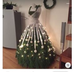 a dress made out of branches with lights on it