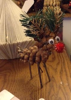 a pine cone christmas tree with googly eyes