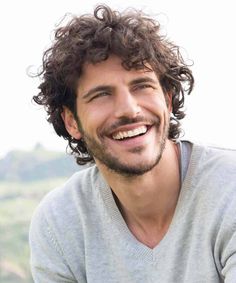 This hairstyle was included in our article ‘12 Long Curly Hairstyles For Men That Look Effortlessly Cool’ Check it out at mensflair.com Long Curly Haircuts, Trendy We Fryzurach, Smiling Man, Boys Long Hairstyles, Haircuts For Curly Hair, Curly Hair Men, Hair Transplant, Long Hairstyles, Long Curly Hair