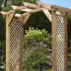 an outdoor wooden arbor with trelliss and flowers