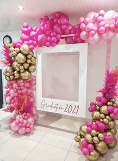 pink and gold balloons in front of a white frame