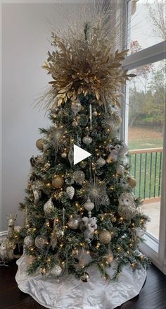 a decorated christmas tree in front of a window