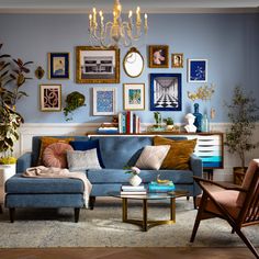 a living room filled with furniture and pictures on the wall