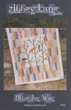 the cover of blue jay way quilts, featuring an image of a tree with birds on it