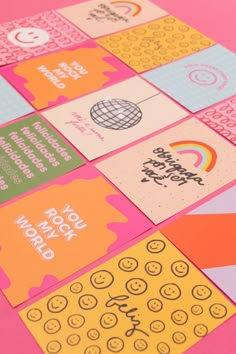 several different colored cards on a pink surface with the words happy new year written across them