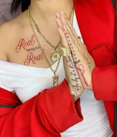 a woman with tattoos on her chest and hands folded in front of her, holding the cross