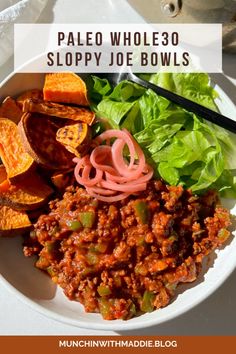 a white plate topped with lots of food next to chips and salad on top of a table