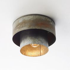 a light that is on the side of a wall in a room with white walls