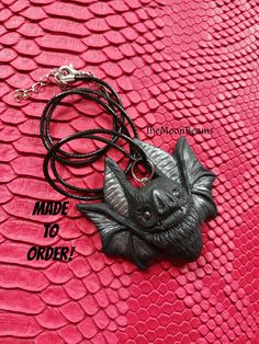 "MADE TO ORDER PROCESSING TIME 2-3 WEEKS It will be created for you, just like the one in the pictures, please allow slight variations due to the handmade nature of the piece, which makes each bat unique :) The new version of my classic Chubby Bat pendant Made by me using Black polymer clay,with silver accents(wings and ears) With Hematite eyes. It is 2\" wide and 2\" tall the back is flat It comes with a black cotton cord 18\" with a 2\" extension chain It comes in a gift box CARE: Please keep Hand Painted Jewelry For Halloween Gift, Spooky Black Necklace For Gift, Handmade Polymer Clay Halloween Jewelry, Handmade Black Vampire Necklace, Handmade Resin Jewelry For Halloween, Hand Painted Polymer Clay Novelty Jewelry, Gothic Hand-cast Halloween Necklaces, Unique Black Halloween Necklace, Hand Painted Black Polymer Clay Jewelry