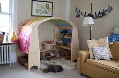 a child's room with a bed, couch and bookshelf in it